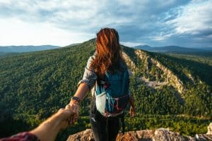 Couple holding hands on the mesmerizing landscape of Nepal